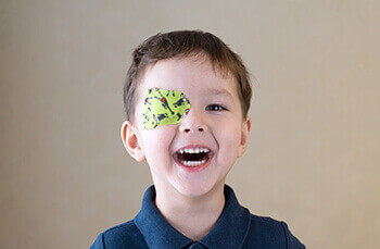 Child with a Lime Green Eye Patch used to fight a Lazy Eye