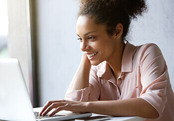 Woman Smiling and researching eye care